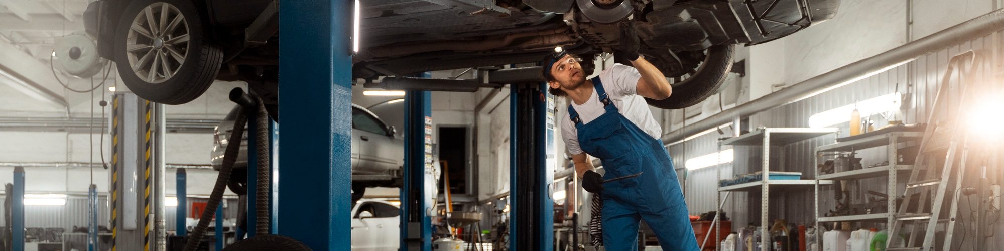 mechanic-working-car-suspension-repair-shop